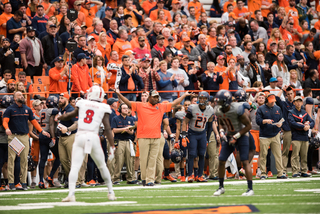 Babers holds both hands up above his shoulders at his side. The Orange crumbled in the second half.